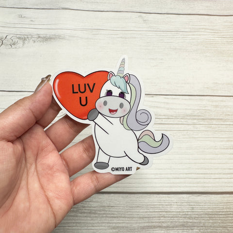 Aurora Unicorn holding a Luv U Heart